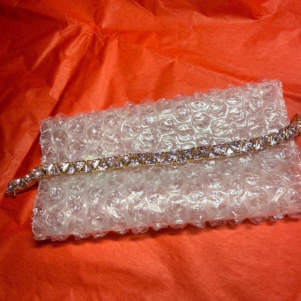 Gold Tennis Bracelet with Zircon Triangle stones, with a slide feature and safty